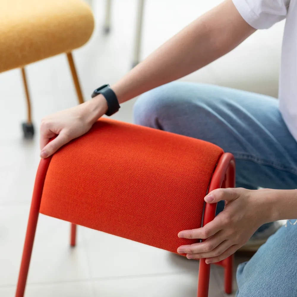 Image of a person holding a stool.