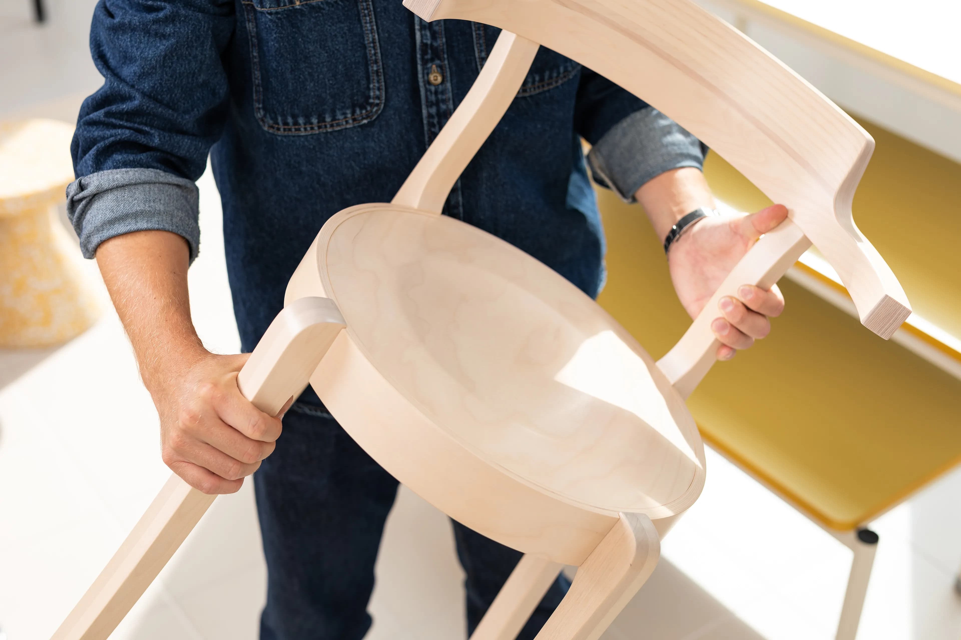 A person holding a chair.